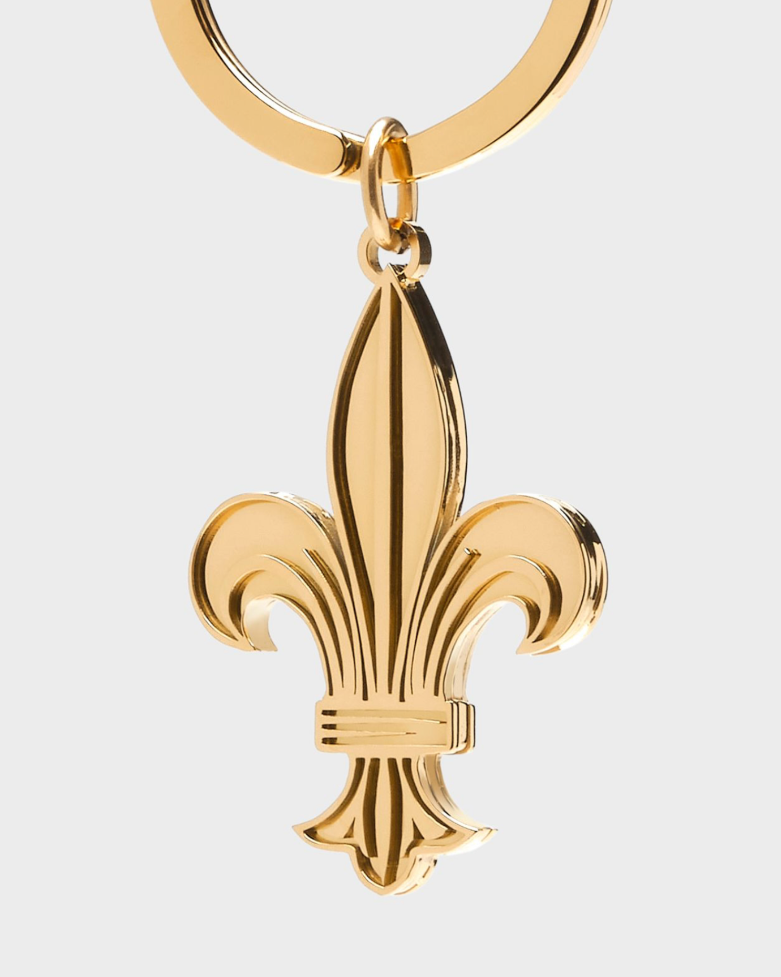 Gold fleur-de-lis keychain on a white background