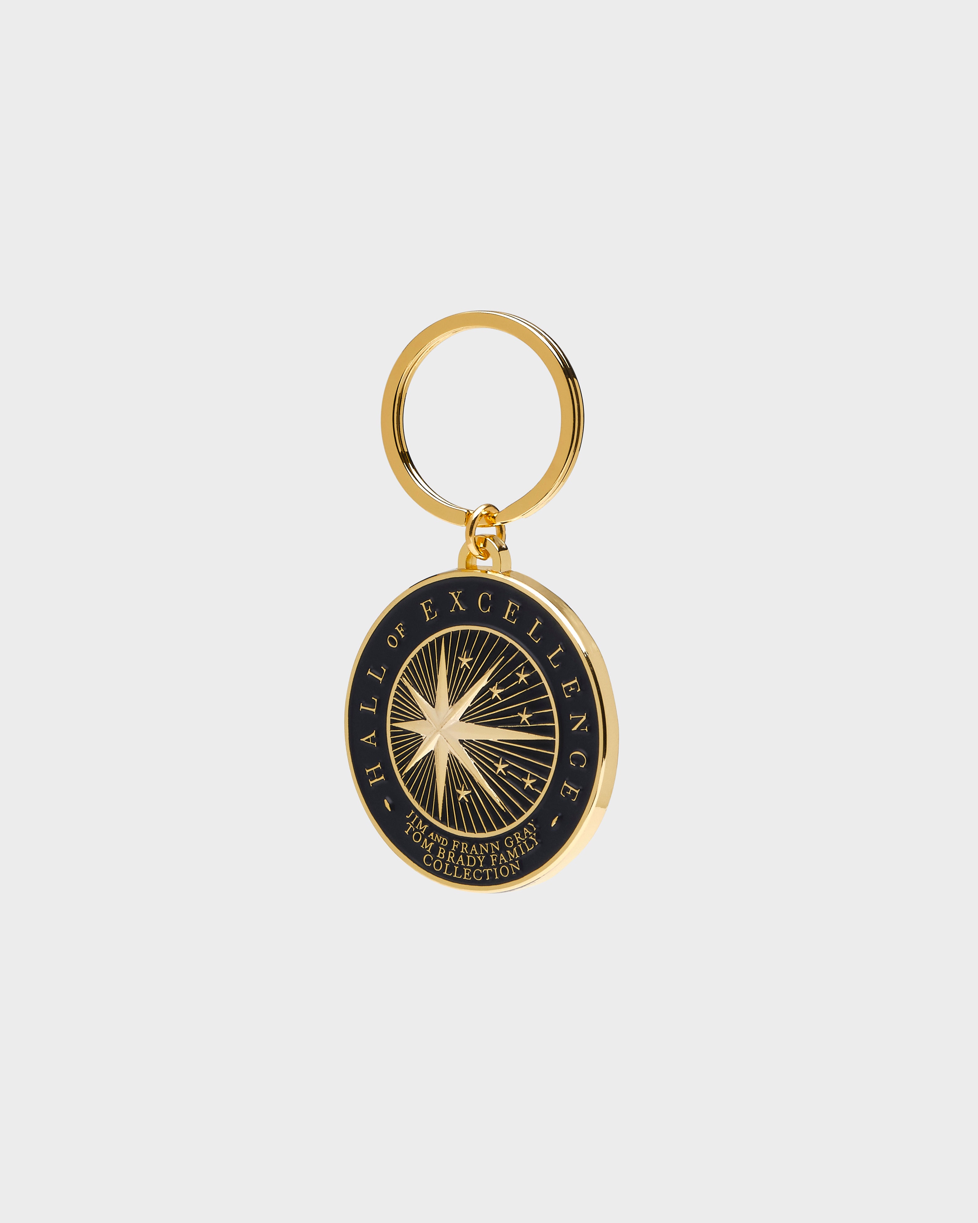 Gold and black keychain with 'Hall of Excellence' design on a white background