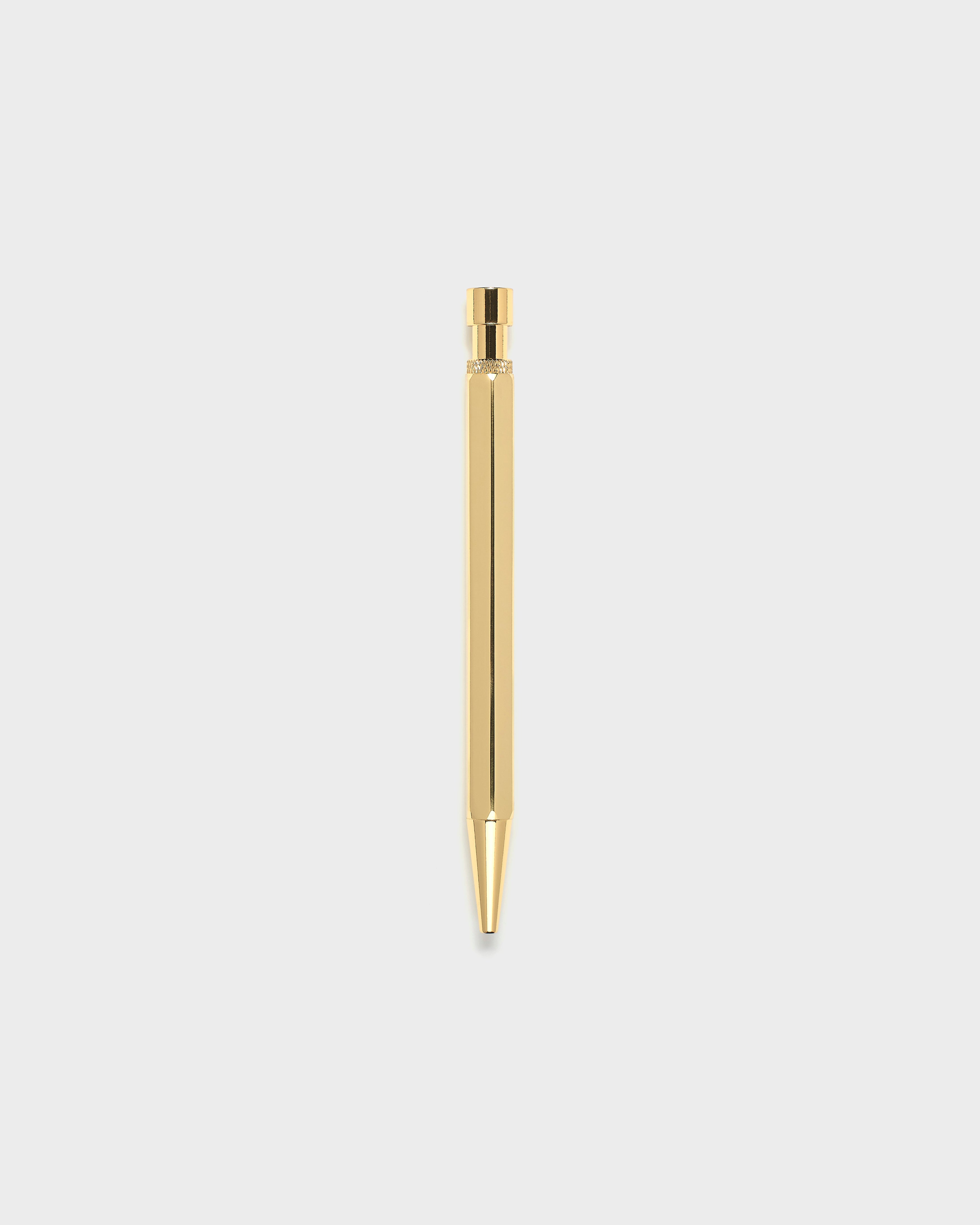 Gold pen on a light gray background