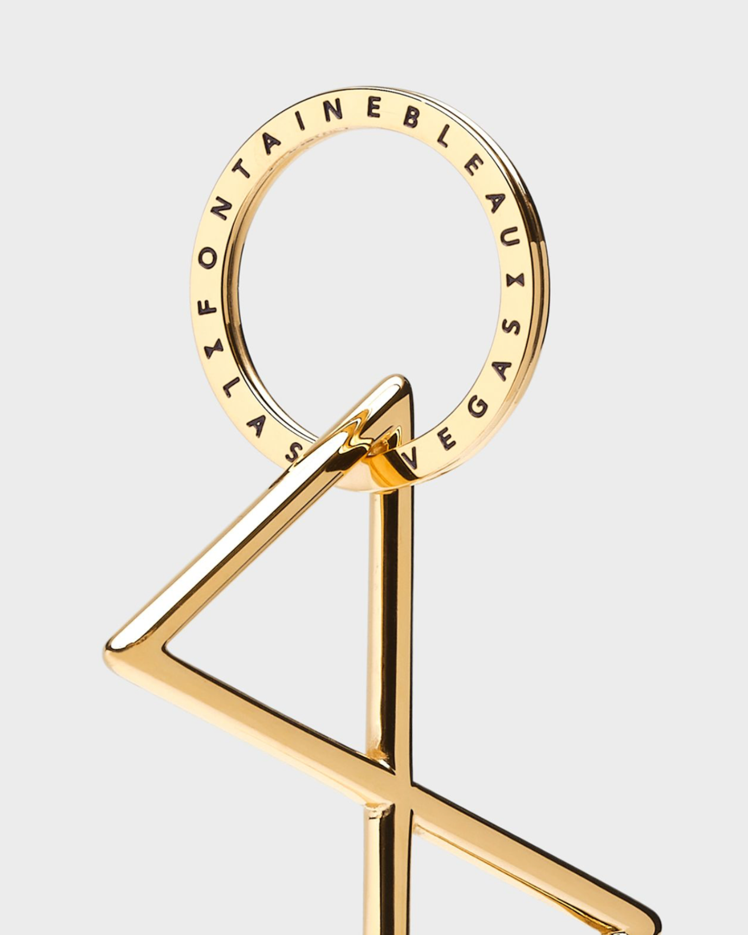 Gold keychain with 'Fontainebleau Las Vegas' text on a white background
