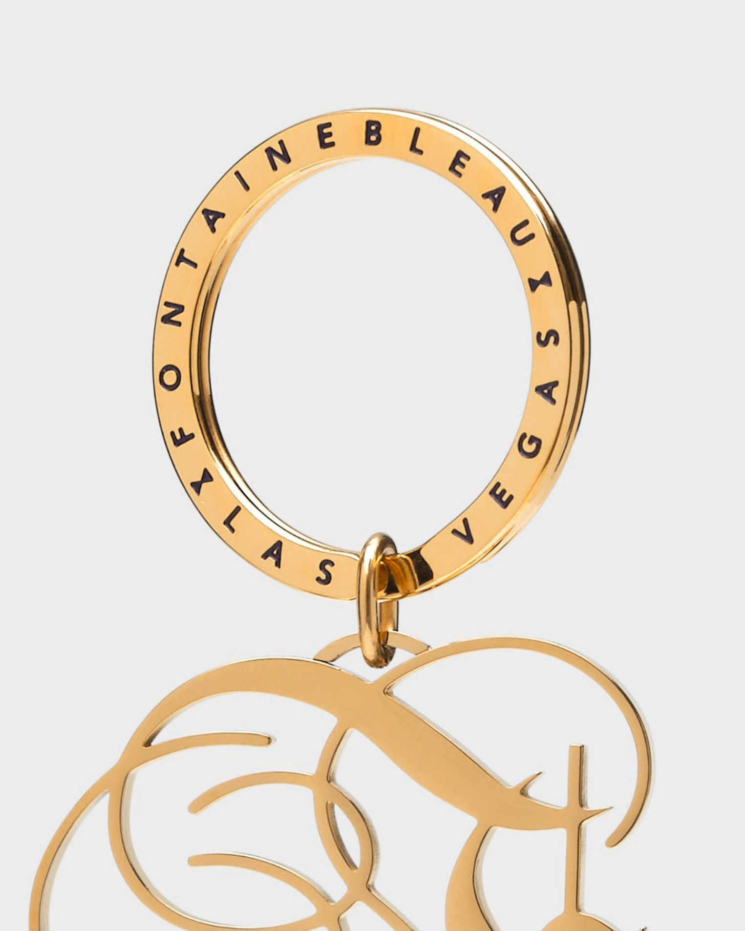 Gold keychain with 'Fontainebleau Las Vegas' text on a white background